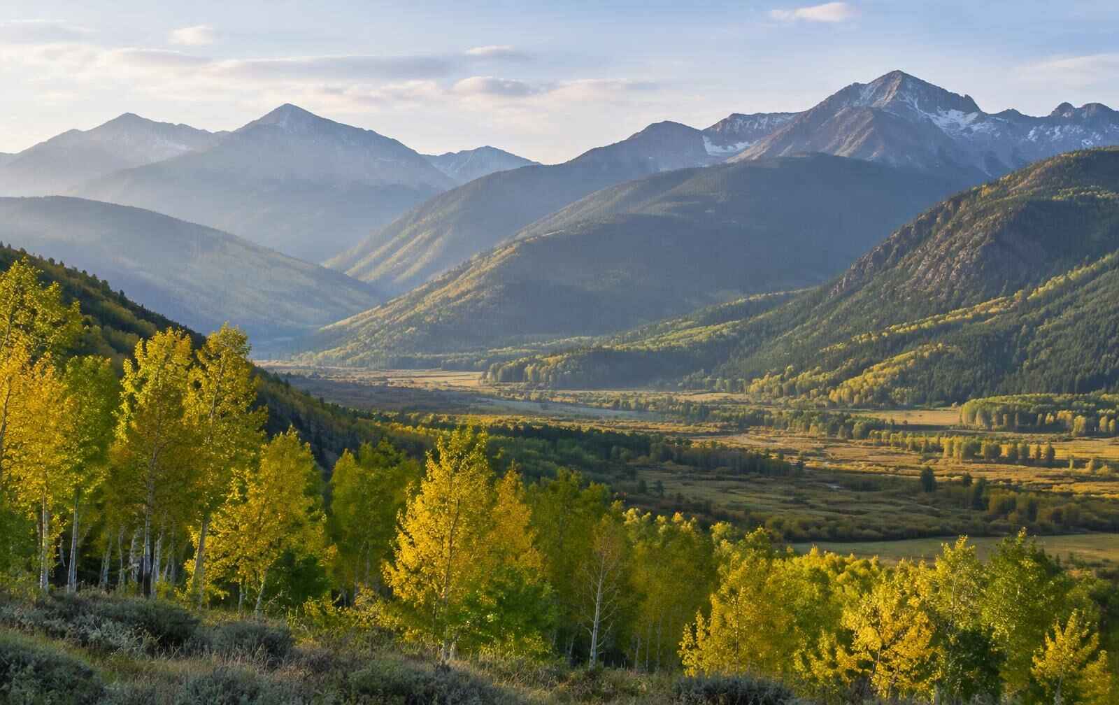 Sunlit mountains and aspen trees in the Roaring Fork Valley